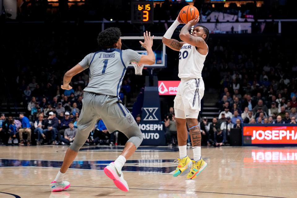Xavier Musketeers guard Dayvion McKnight (20) shoots from three point range in the first half of the NCAA Big East basketball game between the Xavier Musketeers and the Butler Bulldogs at the Cintas Center in Cincinnati on Tuesday, Jan. 16, 2024.