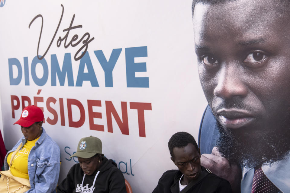 Supporters of presidential candidate Bassirou Diomaye Faye gather outside his campaign headquarters after preliminary results put him as the expected winner, in Dakar, Senegal, Monday, March 25, 2024. Faye's expected victory reflected frustration among youth with high unemployment and concerns about governance in the West African nation. Faye, backed by popular opposition leader Ousmane Sonko, has vowed to protect Senegal from corruption and interference from foreign powers like former colonial master France. (AP Photo/Mosa'ab Elshamy)