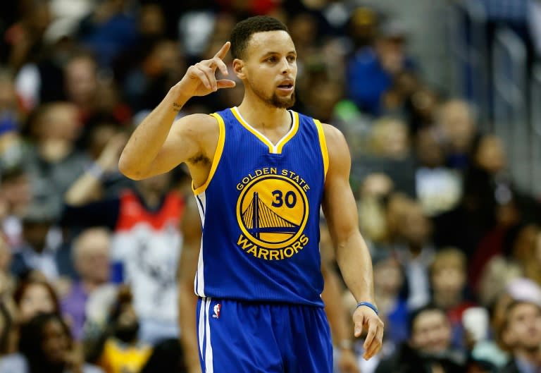 Stephen Curry #30 of the Golden State Warriors celebrates after scoring in the fourth quarter against the Washington Wizards at Verizon Center on February 3, 2016 in Washington, DC