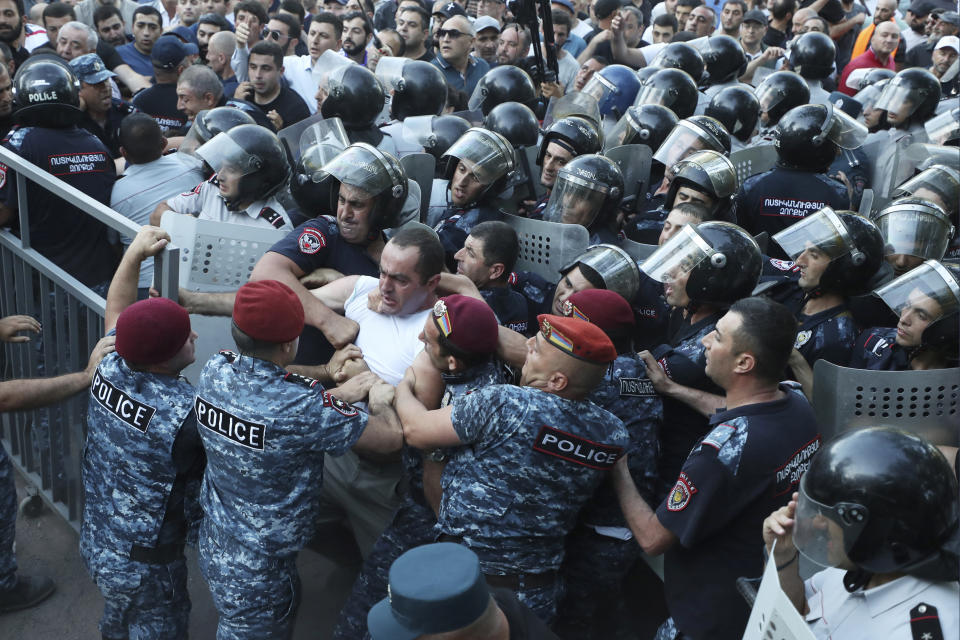 CORRECTS BYLINE - Police block the way to protesters during a rally against Prime Minister Nikol Pashinyan in Yerevan, Armenia, Wednesday, June 12, 2024. (Vahram Baghdasaryan/Photolure via AP)