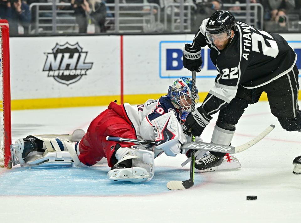 Apr 16, 2022; Los Angeles, California, USA;  Columbus Blue Jackets goaltender Elvis Merzlikins (90) stops a shot by Los Angeles Kings center Andreas Athanasiou (22) in the second period of the game at Crypto.com Arena. Mandatory Credit: Jayne Kamin-Oncea-USA TODAY Sports