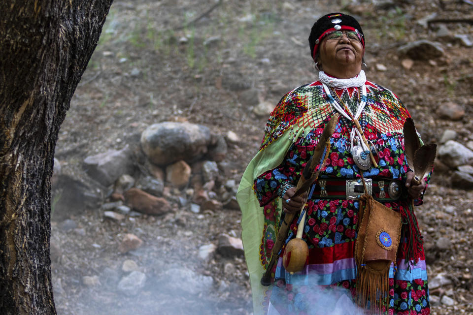 Havasupai tribal member Dianna Sue Uqualla prays near a popular campground site below the rim of the Grand Canyon on Friday, May 5, 2023. The tribe held a blessing ceremony to mark the renaming of the campground from Indian Garden to Havasupai Gardens. (AP Photo/Ty O'Neil)