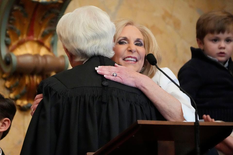Mississippi Attorney General Lynn Fitch, right, hugs Mississippi Supreme Court Chief Justice Michael Randolph, left, after being sworn into office, Thursday, Jan. 4, 2024, in the Mississippi House Chamber at the Mississippi State Capitol, in Jackson.