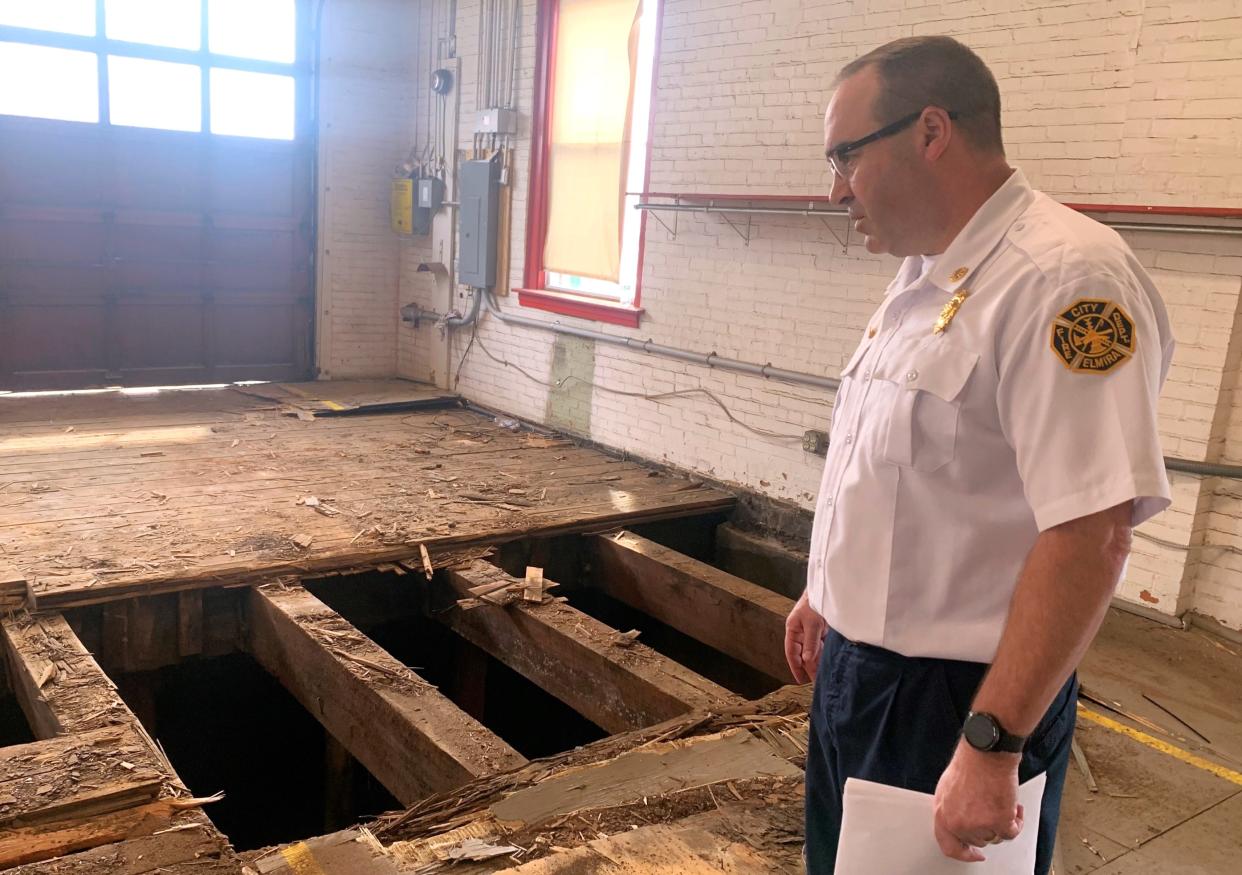 Elmira Fire Chief Andrew Mallow looks over a portion of the deteriorating wooden floor at Fire Station No. 5 that's been ripped up in preparation for replacement with concrete flooring.