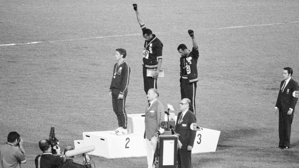 Tommie Smith and John Carlos, gold and bronze medalists in the 200-meter run at the 1968 Olympic Games, engaged in a victory-stand protest against unfair treatment of Black people in the United States. With heads lowered and fists raised in the Black Power salute, they refused to recognize the American flag and national anthem. Australian Peter Norman was the silver medalist. - Bettmann Archive/Getty Images