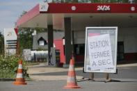 A placard which reads "closed, dried up" is seen at a petrol station in Savenay, France, May 25, 2016. REUTERS/Stephane Mahe