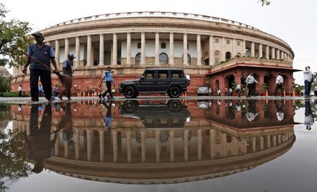 Indian parliament building is reflected in a puddle after the rain in New Delhi, India July 20, 2018. REUTERS/Adnan Abidi