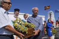 Pilgrims carry the Icon of Virgin Mary during a procession at Panagia Kastriani monastery on the Aegean Sea island of Tzia or Kea, Greece, Monday, Aug. 15, 2022. The Dormition of the Virgin Mary (or Mother of God as the Greeks usually refer to her) is celebrated on Aug. 15. The religious event is coupled with midsummer festivities, known as Panigiria, that often last more than a day with music, culinary feasts and, in many cases, flea markets. (AP Photo/Thanassis Stavrakis)