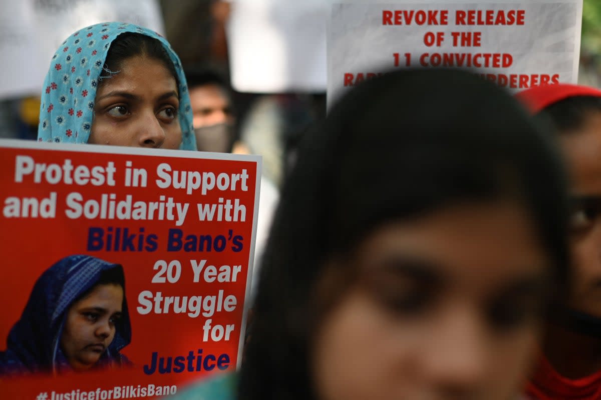 File. Demonstrators hold placards during a protest against the release of men convicted of gang-raping of Bilkis Bano during the 2002 communal riots in Gujarat, in  New Delhi on 27 August 2022 (AFP via Getty Images)