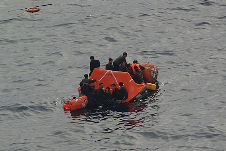 In this Monday, Oct. 7, 2019, photo released by the 9th Regional Japan Coast Guard Headquarters, North Korean fishermen ride on a lifeboat off the northwestern coast of the Noto Peninsula, Ishikawa prefecture, Japan. Japanese authorities said they rescued all of about 60 North Korean fishermen whose boat collided with a Japanese patrol vessel and sank Monday in an area crowded with poachers. (The 9th Regional Japan Coast Guard Headquarters via AP)