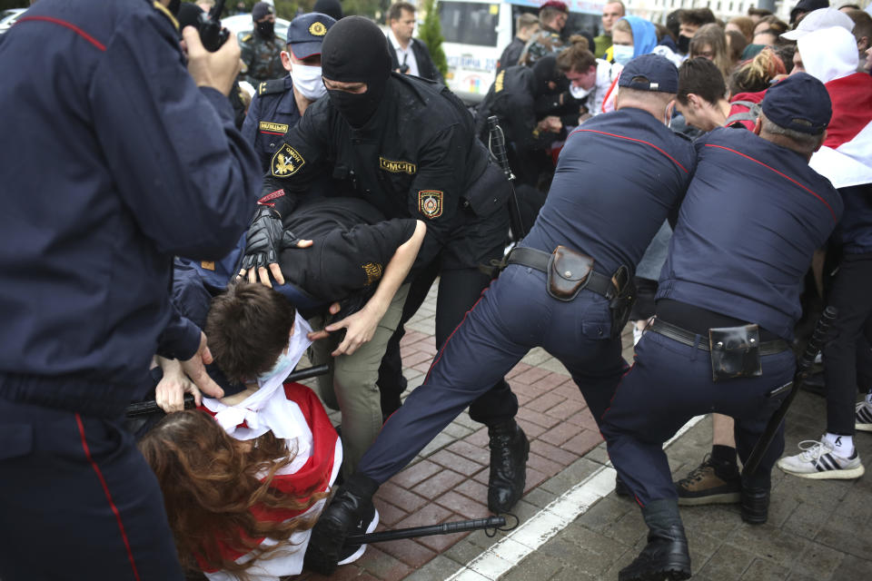 Police detain students during a protest in Minsk, Belarus, Tuesday, Sept. 1, 2020. Several hundred students on Tuesday gathered in Minsk and marched through the city center, demanding the resignation of the country's authoritarian leader after an election the opposition denounced as rigged. Many have been detained as police moved to break up the crowds. (Tut.By via AP)