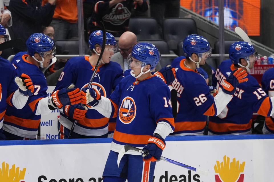 New York Islanders' Bo Horvat (14) celebrates with teammates after scoring a goal against the Ottawa Senators during the first period of an NHL hockey game Thursday, Oct. 26, 2023, in Elmont, N.Y. (AP Photo/Frank Franklin II)