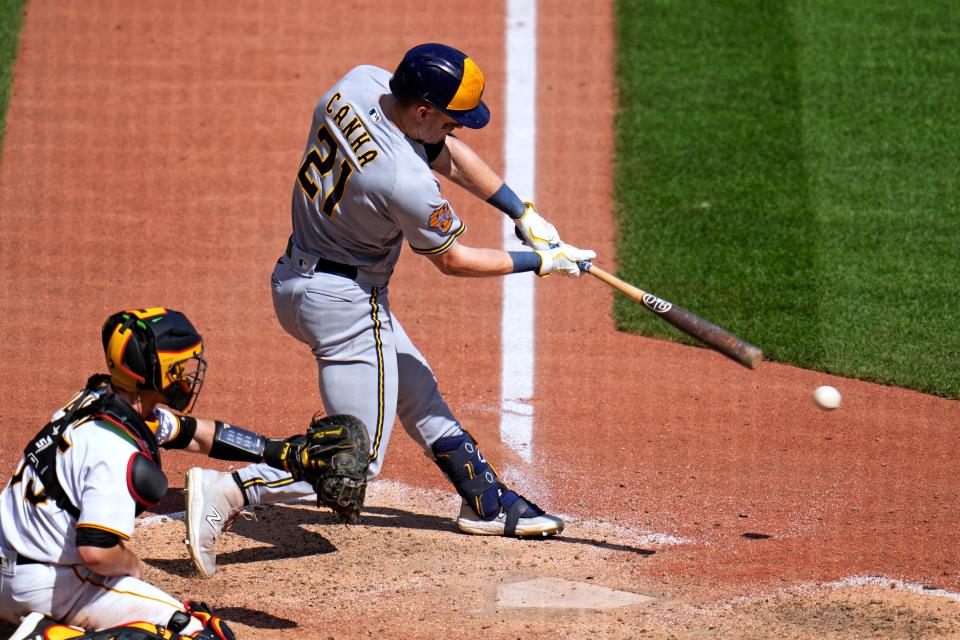Milwaukee Brewers' Mark Canha (21) singles off Pittsburgh Pirates relief pitcher Colin Holderman, driving in a run during the eighth inning of a baseball game in Pittsburgh, September 6, 2023.