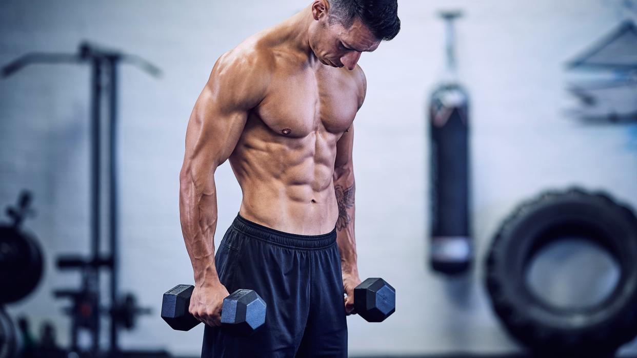  a photo of a man holding dumbbells 