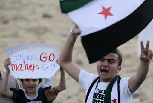 A Syrian resident in Jordan holds a pre-Baath national flag during a demonstration outside the Syrian embassy in Amman on June 22. A Syrian air force colonel won political asylum after landing his MiG fighter in Jordan, as a watchdog reported the deadliest day of fighting in Syria since the battered April ceasefire