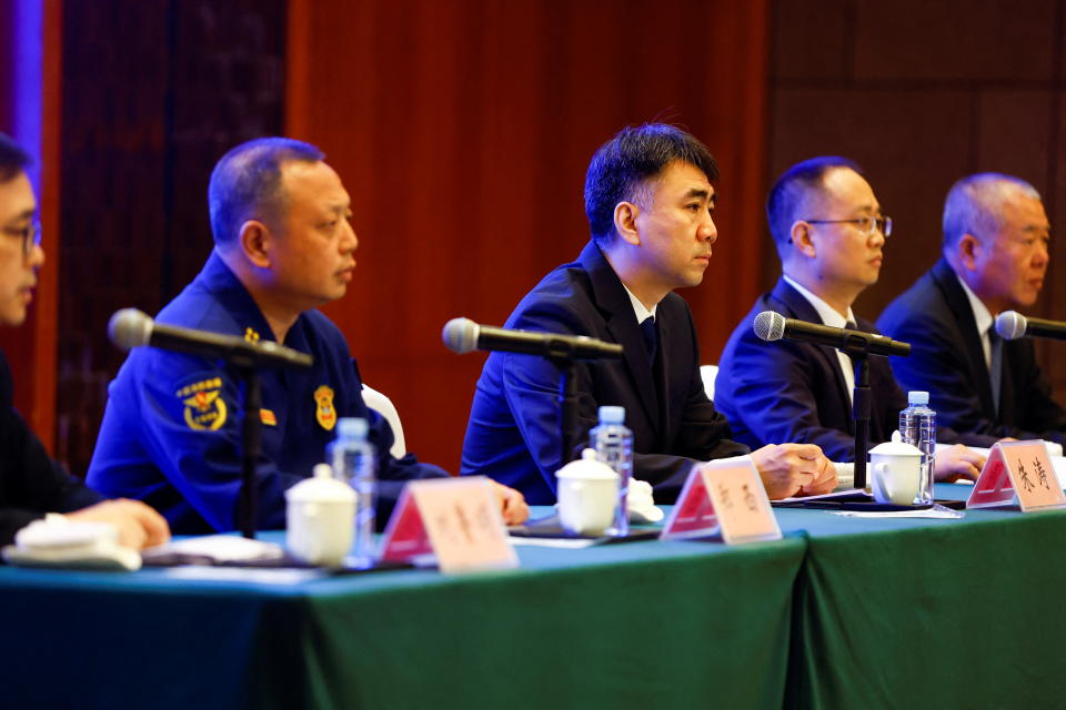 Liu Lusong, spokesperson of Civil Aviation Administration of China (CAAC) and other officials attend a news briefing about the crash on Tuesday 