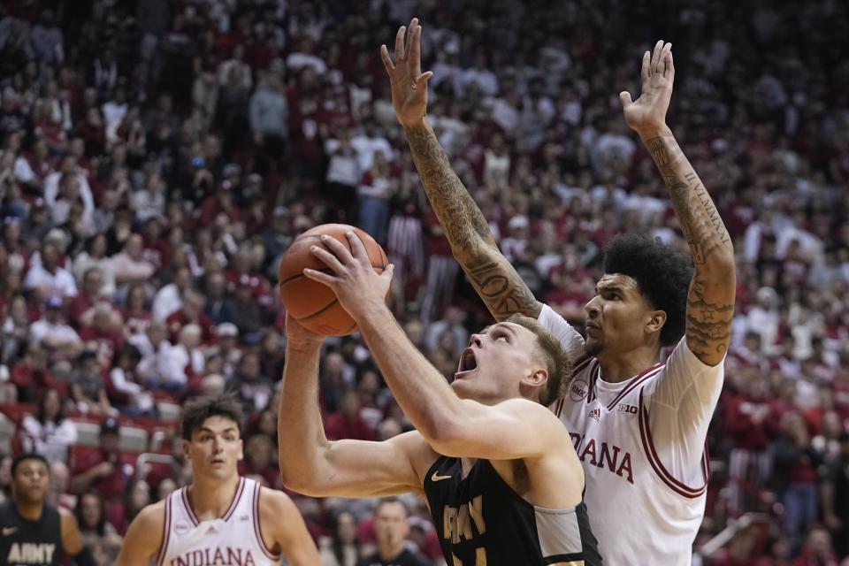 Army's Charlie Peterson puts up a shot against Indiana's Kel'el Ware during the first half of an NCAA college basketball game, Sunday, Nov. 12, 2023, in Bloomington, Ind. (AP Photo/Darron Cummings)