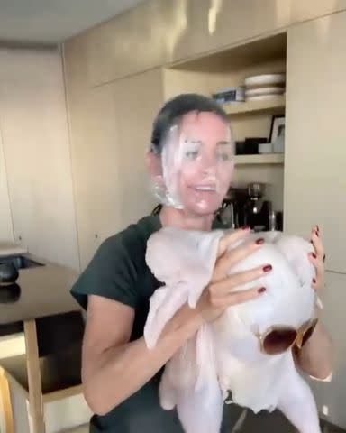 Courteney Cox/Instagram Courteney Cox putting a turkey on her head