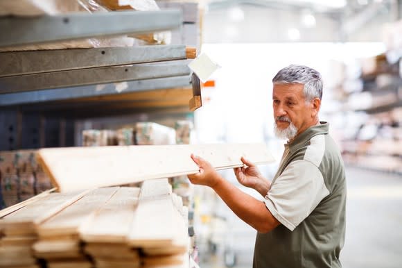 Man picking lumber at a home improvement store.