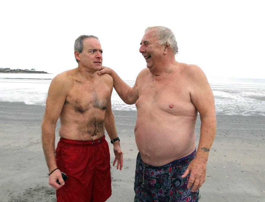 Journal columnist Mark Patinkin shares a moment with Newport Polar Bear Charlie Wright after taking a dip at Easton's Beach on Dec. 23, 2014.