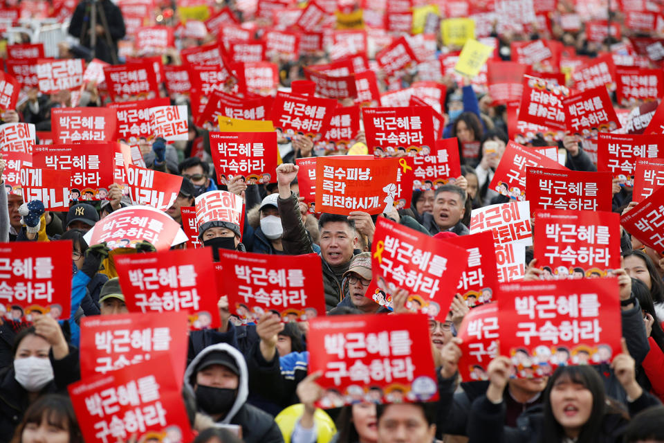 People chant slogans during a protest in Seoul