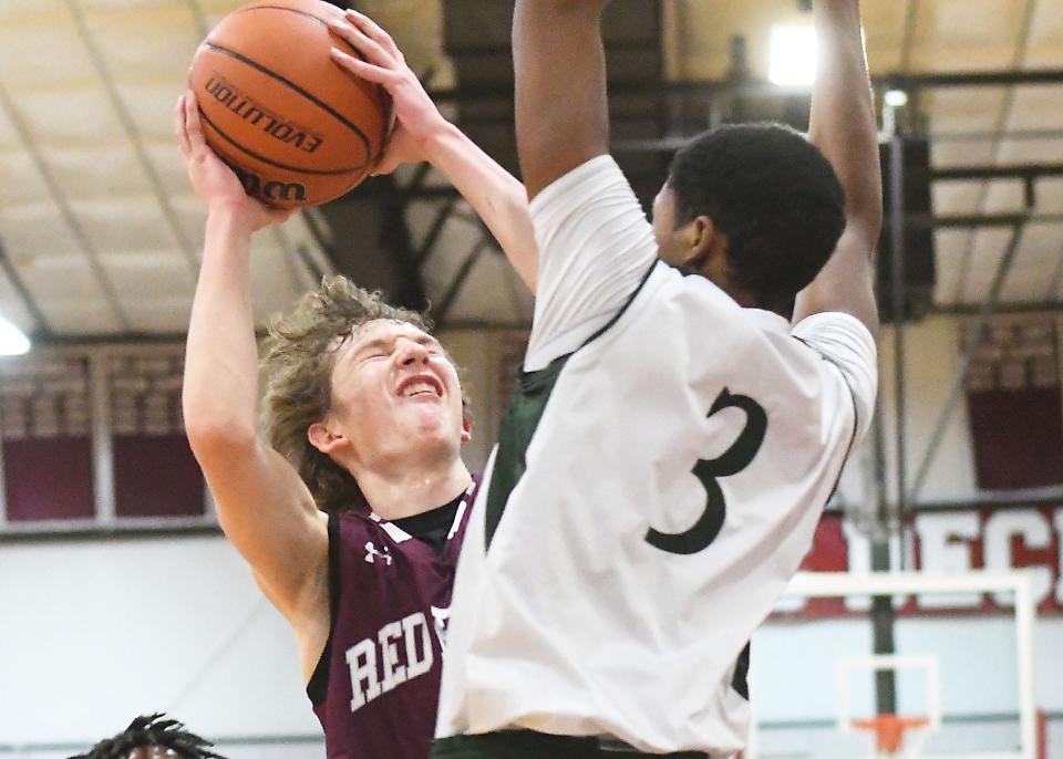 Red Bank's Ryan Fisher goes to shoot over Long Branch's Peter Da' Cruz as Red Bank Regional Boys Basketball defeats Long Branch 66-39 at the Albert E. Martin Buc Classic