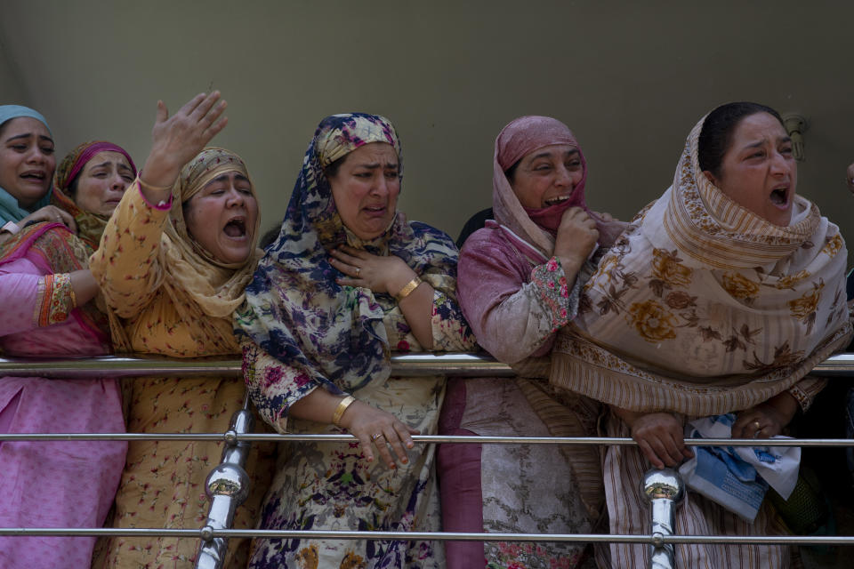 Relatives of Kashmiri civilian Bashir Ahmed Khan grieve as they watch his funeral on the outskirts of Srinagar, Indian controlled Kashmir, Wednesday, July 1, 2020. Suspected rebels attacked paramilitary soldiers in the Indian portion of Kashmir, killing Khan and a paramilitary soldier, according to government sources. The family refutes the claim. (AP Photo/ Dar Yasin)