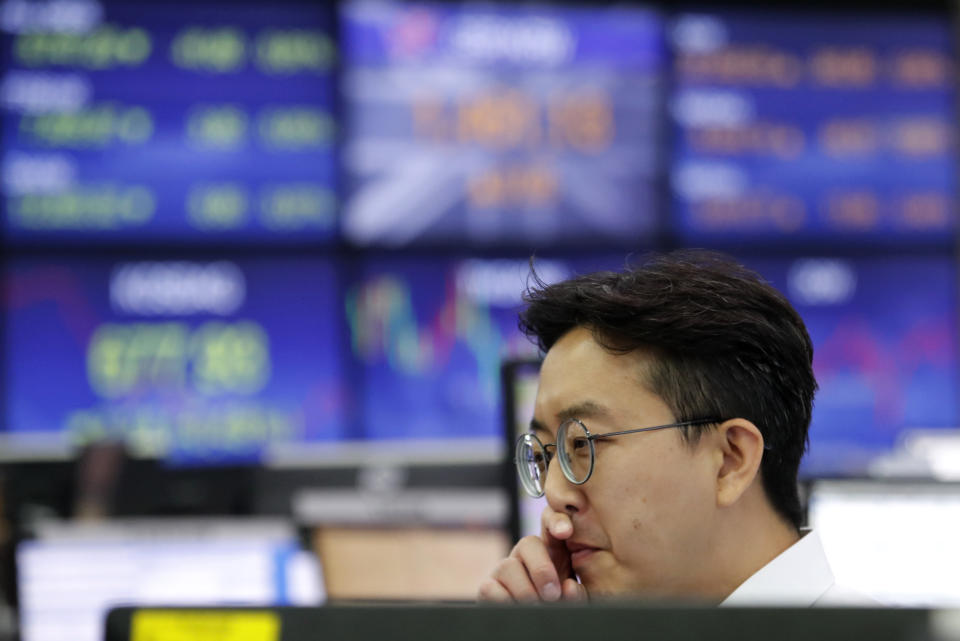 A currency trader watches monitors at the foreign exchange dealing room of the KEB Hana Bank headquarters in Seoul, South Korea, Monday, July 15, 2019. Shares are mixed in Asia, led by gains in Chinese markets after the government reported that the economy grew at the slowest pace in a decade in the last quarter. (AP Photo/Ahn Young-joon)