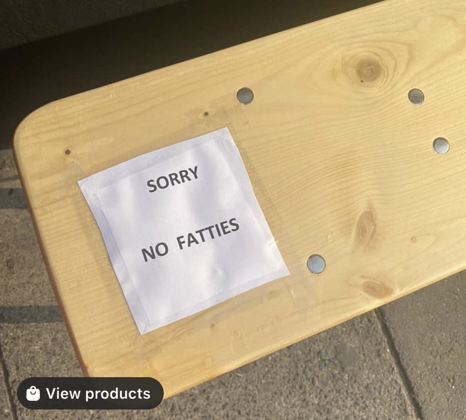 A sign placed on a bench outside the coffee shop caused uproar in the local community and on social media