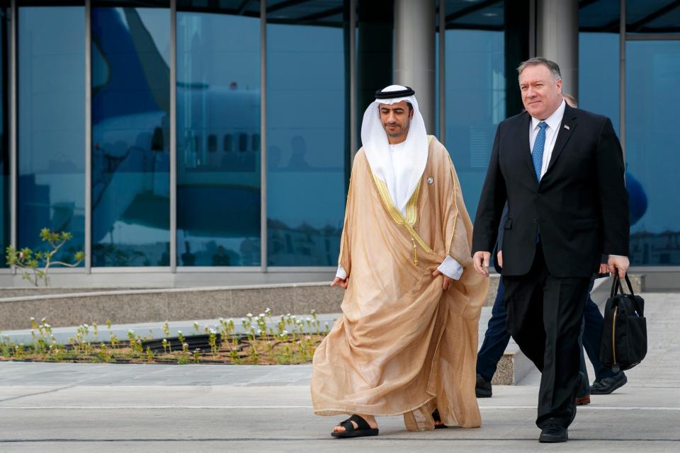 As his plane is reflected in the glass building behind them, Secretary of State Mike Pompeo, right, walks with Abu Dhabi Assistant Foreign Ministry Undersecretary for Protocol Affairs Shihad Al Faheem, as they say goodbye on the secretary's departure from Abu Dhabi, United Arab Emirates, Tuesday, June 25, 2019, en route to an undisclosed location.