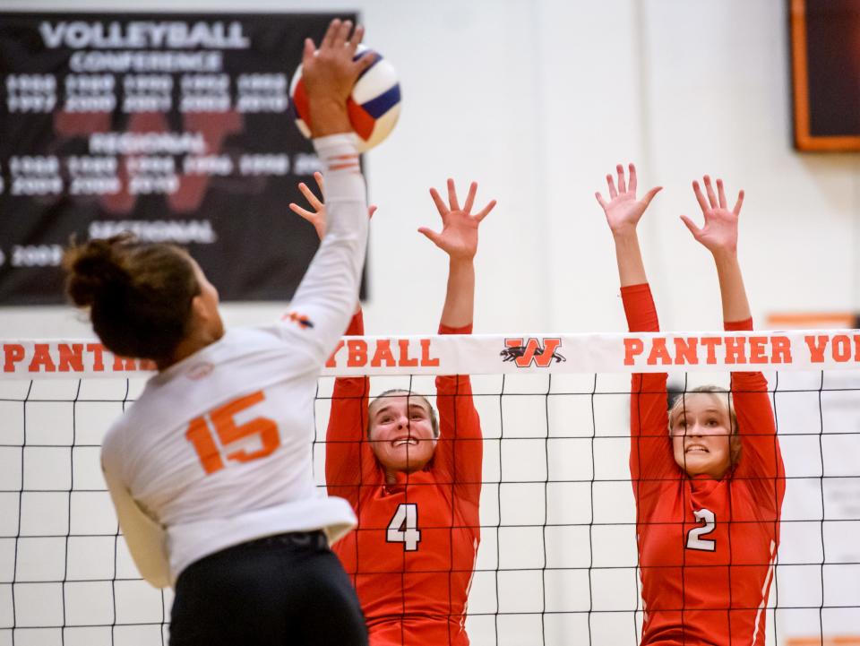 Metamora's Bella Gregory (2) and Victoria Hall (4) defend against Washington's Teriana Jones in the second set Tuesday, Sept. 6, 2022 in Washington. The Redbirds defeated the Panthers in straight sets, 25-12 and 25-18.