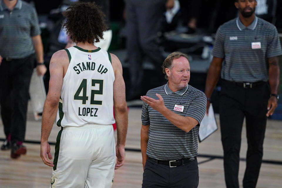 Milwaukee Bucks head coach Mike Budenholzer questions an official during the second half of an NBA basketball game against the Brooklyn Nets Tuesday, Aug. 4, 2020 in Lake Buena Vista, Fla. (AP Photo/Ashley Landis)