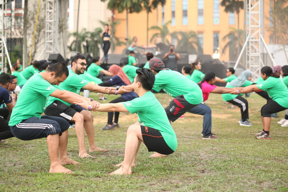 Relayers take part in a warm up activity during the event. — Picture courtesy of the National Cancer Society of Malaysia