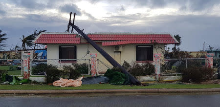 A downed power line sits on a damaged building after Super Typhoon Yutu hit Saipan, Northern Mariana Islands, U.S., October 25, 2018 in this image taken from social media. Brad Ruszala via REUTERS