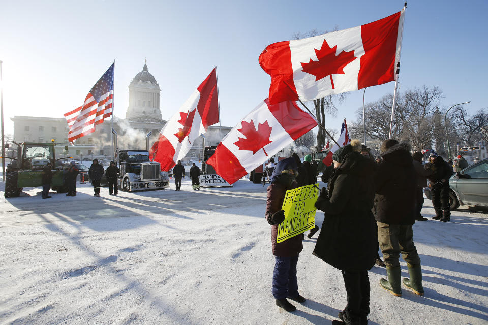 Demonstrators rally against provincial and federal COVID-19 vaccine mandates and in support of Ottawa protestors, Friday, Feb. 4, 2022, outside the Manitoba Legislature in Winnipeg, Manitoba. (John Woods/The Canadian Press via AP)