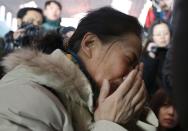 A relative of a passenger onboard Malaysia Airlines flight MH370 cries, surrounded by journalists, at the Beijing Capital International Airport in Beijing March 8, 2014. The Malaysia Airlines flight carrying 227 passengers and 12 crew lost contact with air traffic controllers early on Saturday en route from Kuala Lumpur to Beijing, the airline said in a statement. Flight MH 370, operating a Boeing B777-200 aircraft departed Kuala Lumpur at 12.21 a.m. (1621 GMT Friday) and had been expected to land in the Chinese capital at 6.30 a.m. (2230 GMT) the same day. REUTERS/Kim Kyung-Hoon (CHINA - Tags: TRANSPORT DISASTER)