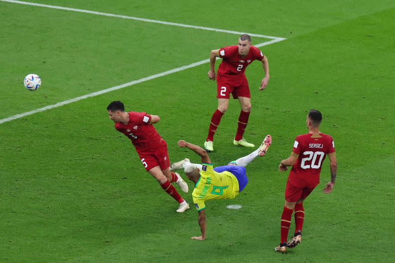 Brazil's forward #09 Richarlison scores his team's second goal during the Qatar 2022 World Cup Group G football match between Brazil and Serbia at the Lusail Stadium in Lusail, north of Doha on November 24, 2022. (Photo by Giuseppe CACACE / AFP)