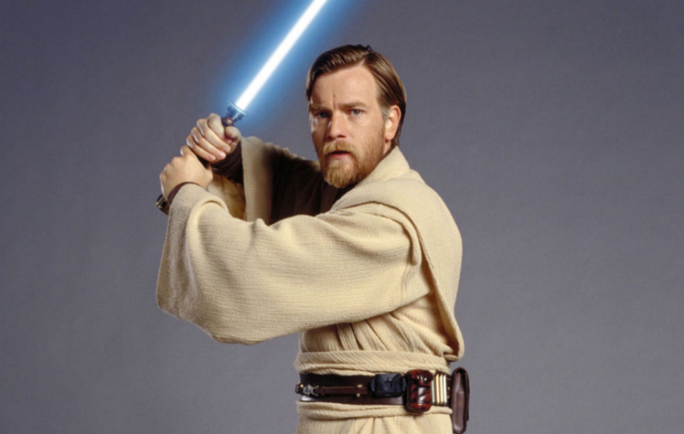 Obi-Wan holds a lightsaber