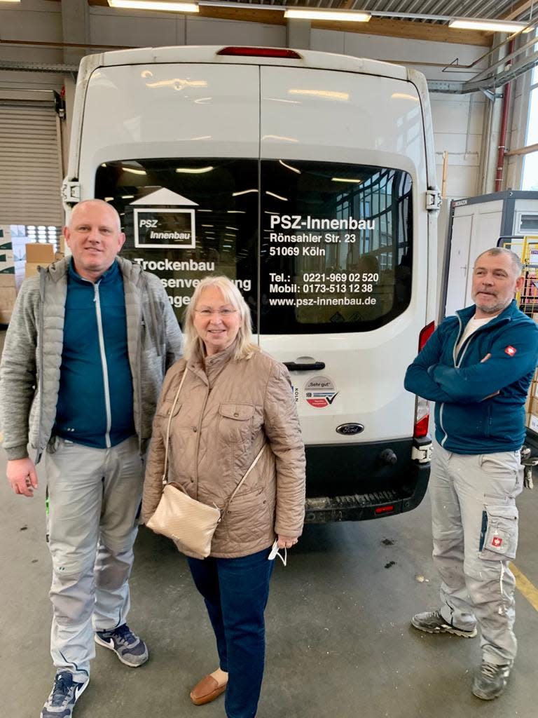 Vera Busch, center, stands with her husband, Dr. Ulrich Busch, left, in front of a van used to transport supplies to Ukraine.