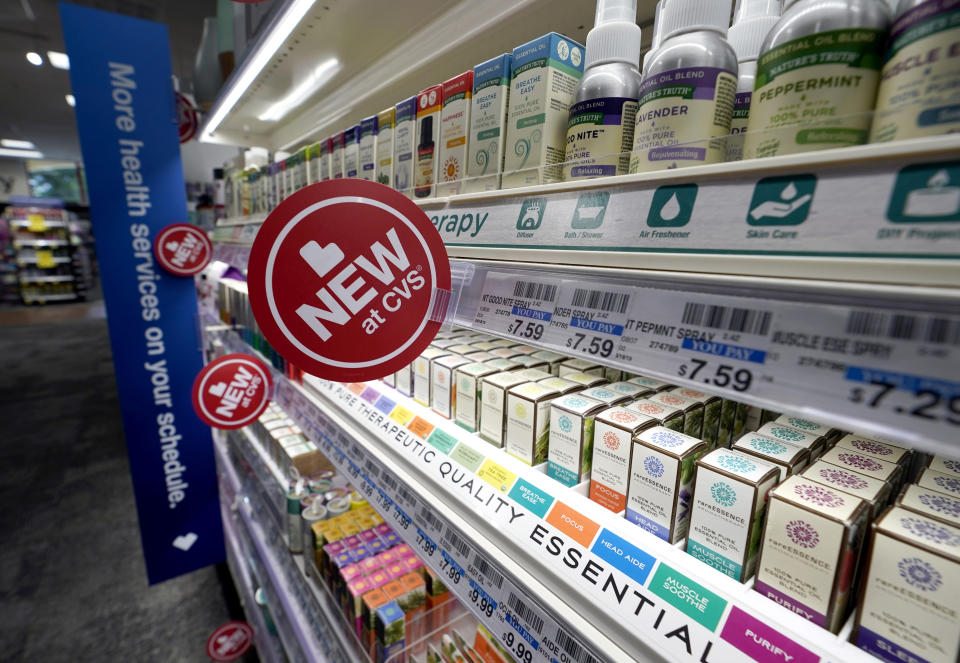 FILE- In this May 30, 2019, file photo, signs advertise new products available inside a CVS store with the new HealthHUB in Spring, Texas. On Wednesday, June 12, the Labor Department reports on U.S. consumer prices for May. (AP Photo/David J. Phillip, File)