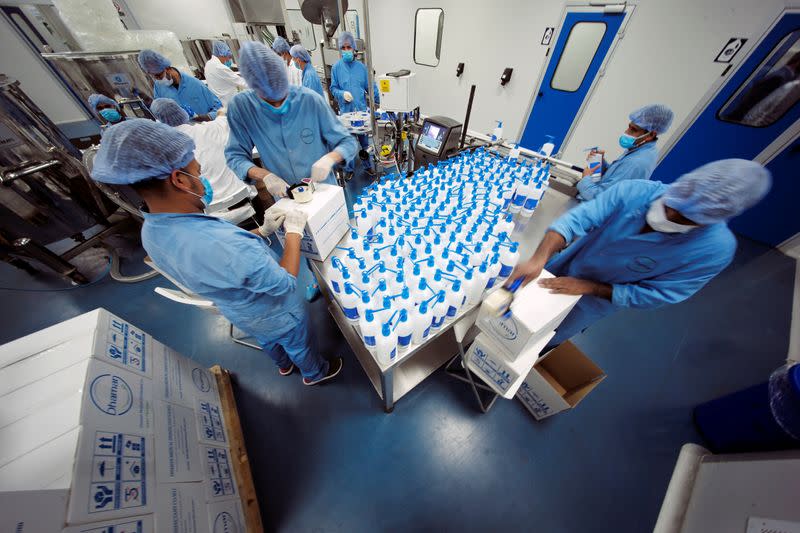 Employees pack hand sanitizers at Dhaman Medical Company, following the outbreak of the coronavirus disease (COVID-19), in Hidd