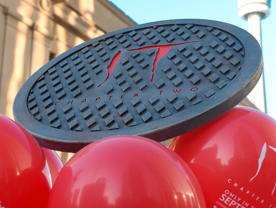 A manhole cover floating on top of balloons as advertising for IT: Chapter Two