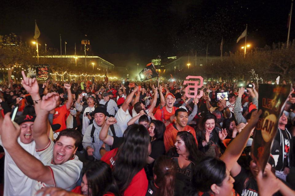 Fans celebrate after the San Francisco Giants defeated the Kansas City Royals to win the World Series during a television viewing event at the Civic Center in San Francisco