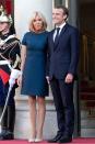 <p>In a blue a-line dress and nude heels for a reception for the French national football team. </p>