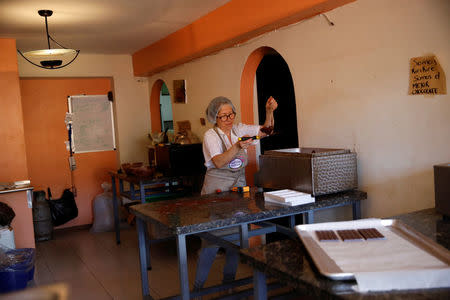 Nancy Silva makes chocolate bars at the Kirikire chocolate factory in Caracas, Venezuela October 4, 2017. REUTERS/Carlos Garcia Rawlins