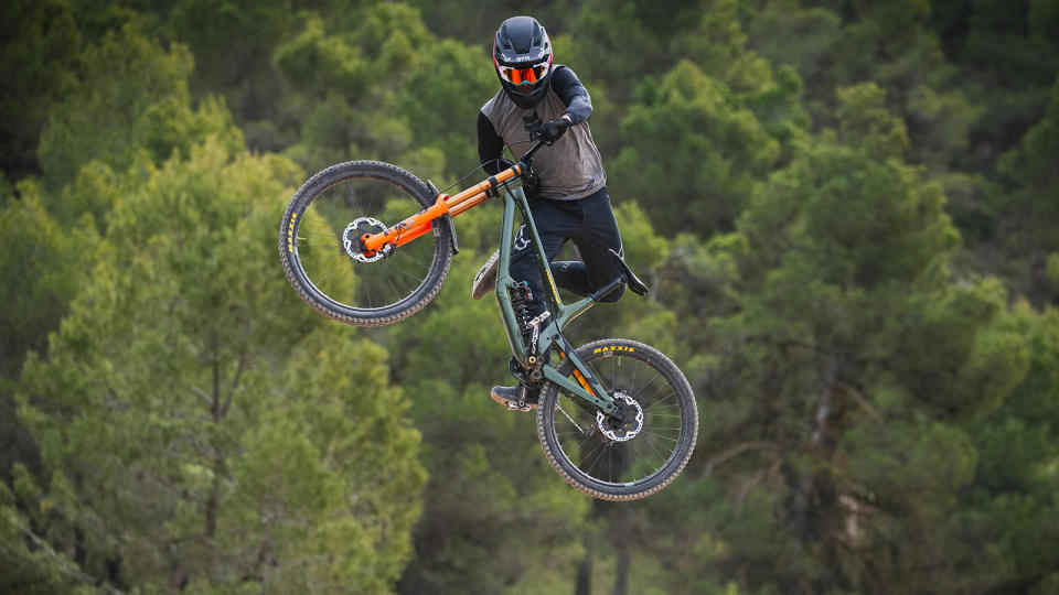 Greg Minnaar doing a one footed whip on a norco downhill bike
