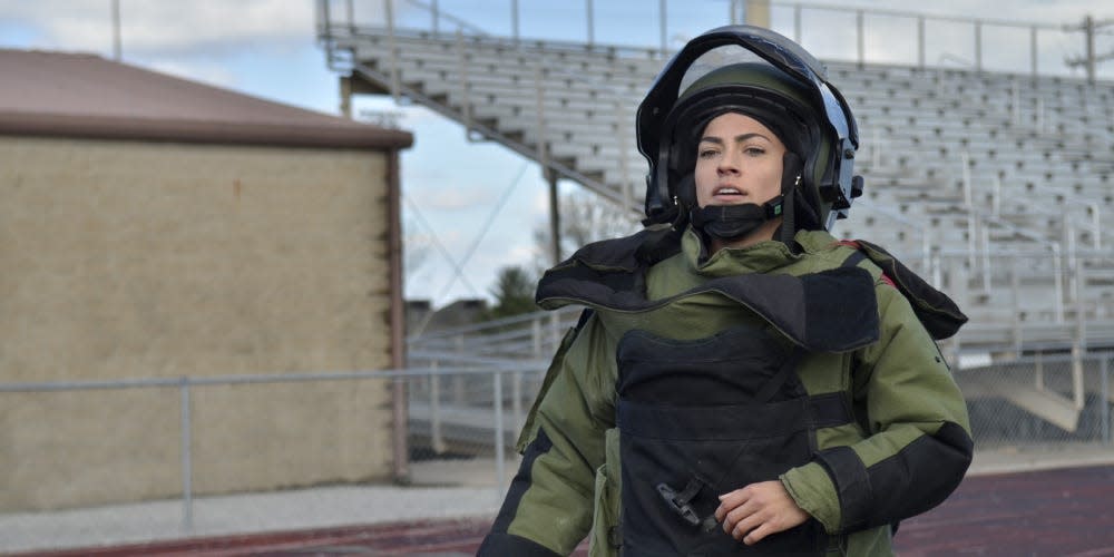 Captain Kaitlyn Hernandez, commander, 717th Ordnance Company, 52nd Ordnance Group (Explosive Ordnance Disposal), trains at Fryar Stadium March 28 in preparation to set the Guinness World Record for the fastest woman to run 1-mile in a bomb suit.