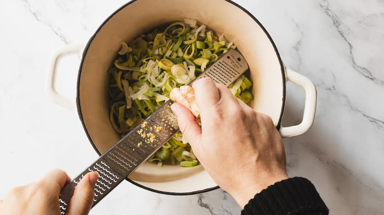 Grating ginger into pot