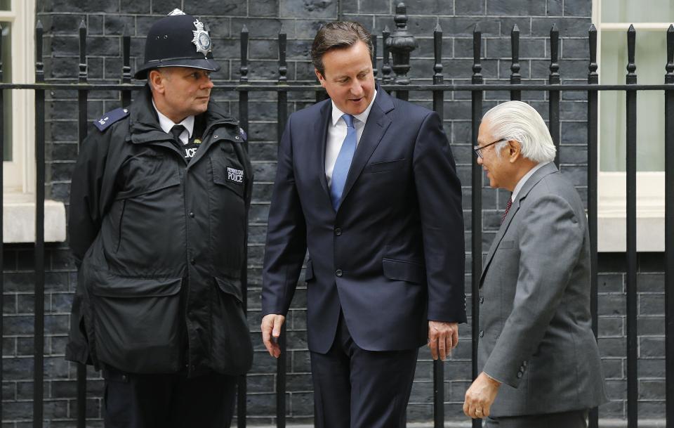 Britain's Prime Minister David Cameron greets the President of Singapore Tony Tan outside Number 10 Downing Street in London