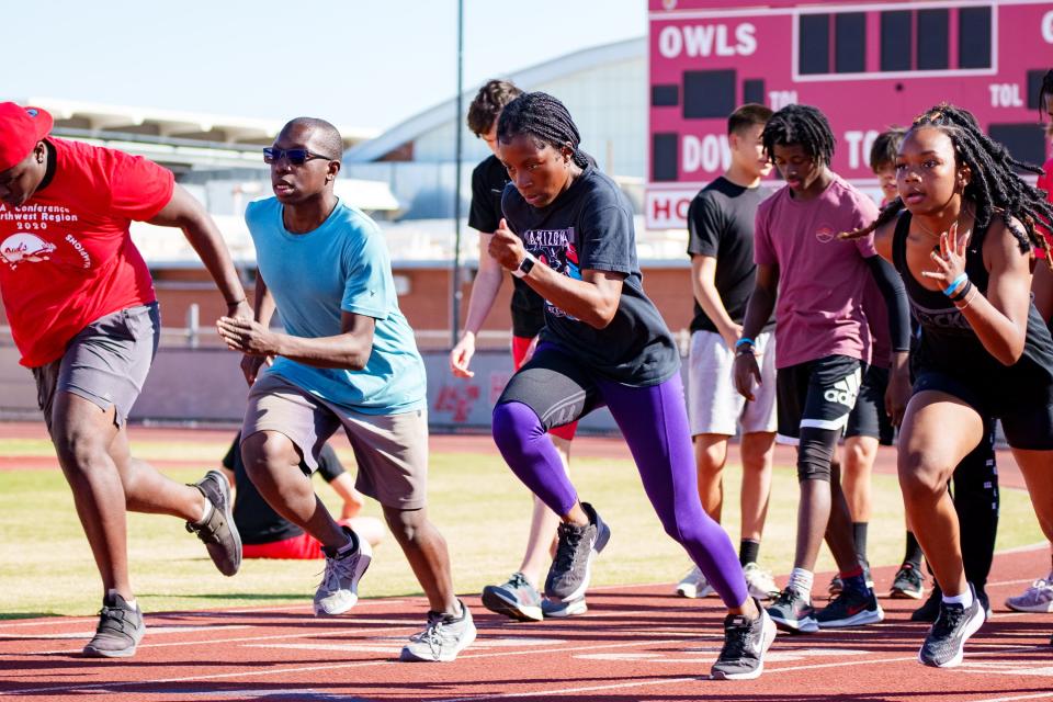 Stacey Onyepunuka, third from left, warms up at practice at the Agua Fria High School track on March 21, 2022 in Avondale, AZ.